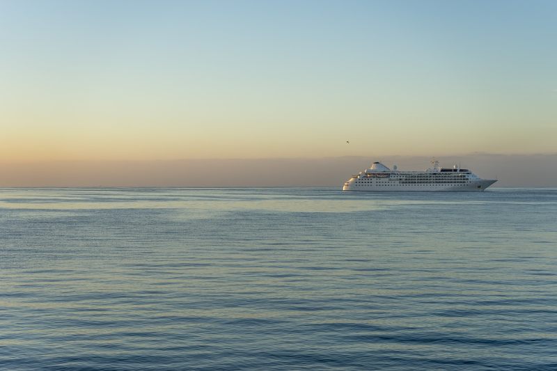 Cruise ship with sun in background